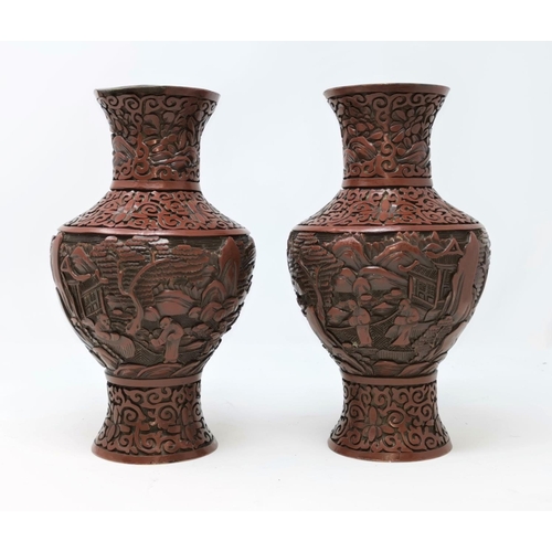 325B - A pair of Chinese cinnabar vases with traditional scenes height 23cm (some areas of damage)