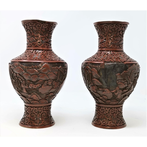 325B - A pair of Chinese cinnabar vases with traditional scenes height 23cm (some areas of damage)