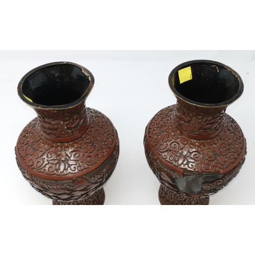 325B - A pair of Chinese cinnabar vases with traditional scenes height 23cm (some areas of damage)