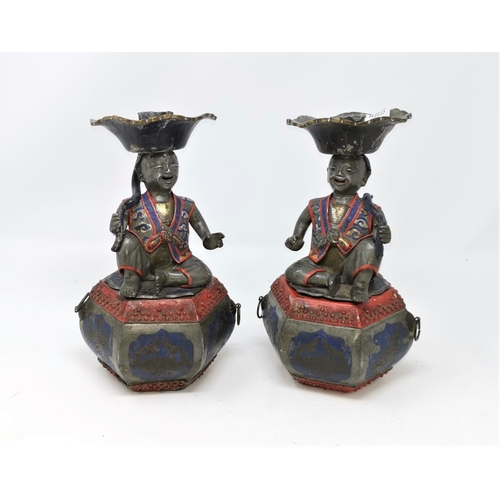 368 - A pair of unusual Chinese pewter candle sticks in the form of characters sat on box with space for i... 