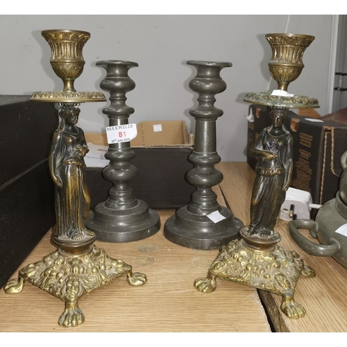 81 - A pair of 19th century pewter candlesticks, 21cm; a pair of brass figural candlesticks, 24cm