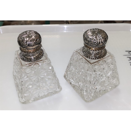 429 - A pair of conical cut glass salts with embossed silver lids