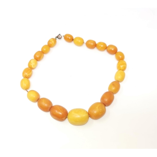455A - An unpolished amber necklace, 78gm, largest bead 3cm, overall length 46cm