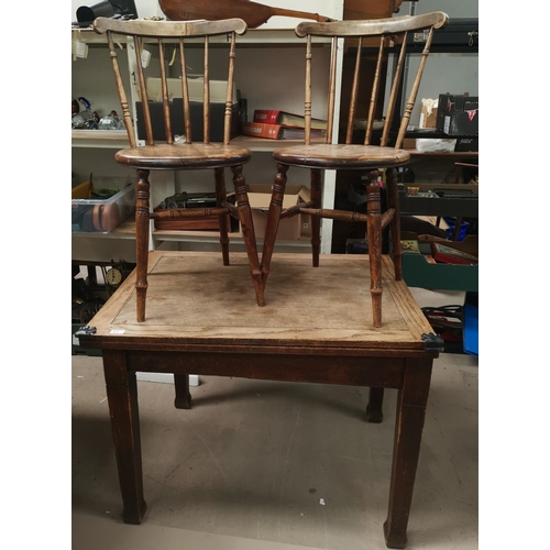 616 - A 1930's oak fold-over dining table and 2 spindle back chairs