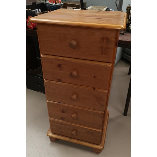 619 - A pine 5 height narrow chest of drawers; a glass occasional table/magazine rack