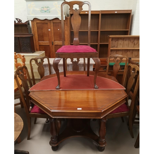 624 - A reproduction walnut dining table with octagonal top, and a set of walnut dining chairs in the Quee... 