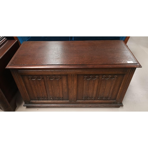 627 - A small oak blanket chest with panel front in the Jacobean style; a turned oak standard lamp