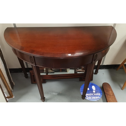 655 - A pair of Georgian style mahogany demi-lune side tables combining to form a dining table with centra... 