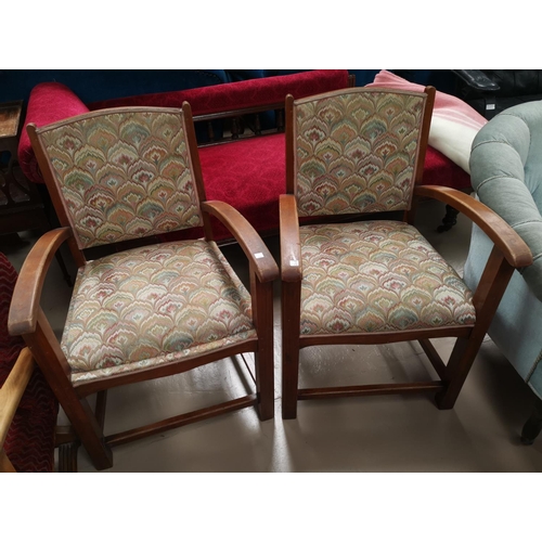 656 - A pair of 1930's oak framed open armchair in patterned tapestry fabric