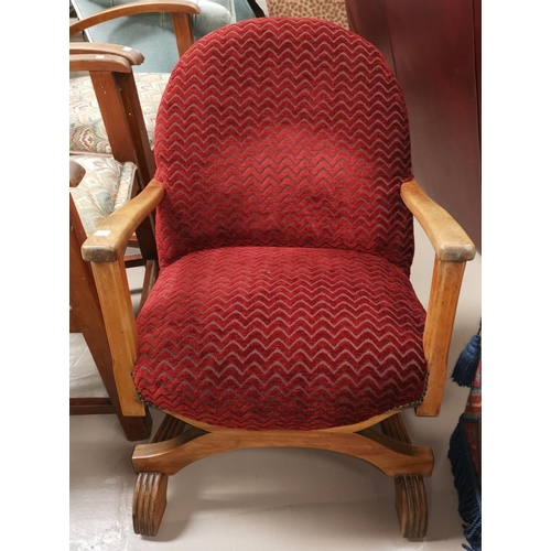 660 - A 1930's low seat cross framed armchair in red moquette