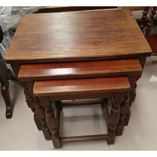 664 - A nest of 3 oak occasional tables; a magazine rack