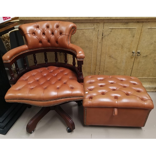 670 - A swivel armchair and stool in button tan hide