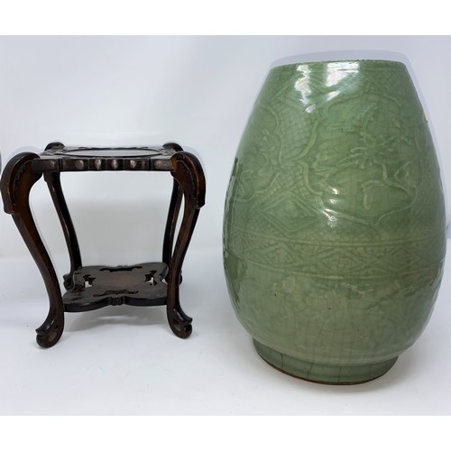 343A - A Chinese celadon crackle glaze ovoid shaped stoneware vase on tall hardwood stand. Vase height 28cm