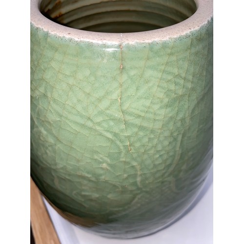 343A - A Chinese celadon crackle glaze ovoid shaped stoneware vase on tall hardwood stand. Vase height 28cm