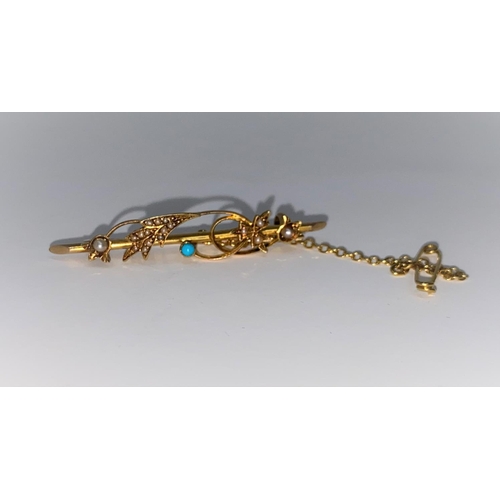 389 - A gold brooch set with seed pearls and small turquoise, marks unclear but tests as 18 carat, 3.2gm