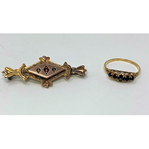 357 - A 9 carat hallmarked gold dress ring, the Victorian style split shank set 5 graduating sapphire colo... 