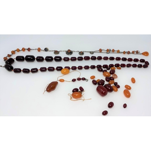 424 - A cherry amber Bakelite coloured necklace with clear oval beads and a selection of loose amber and c... 