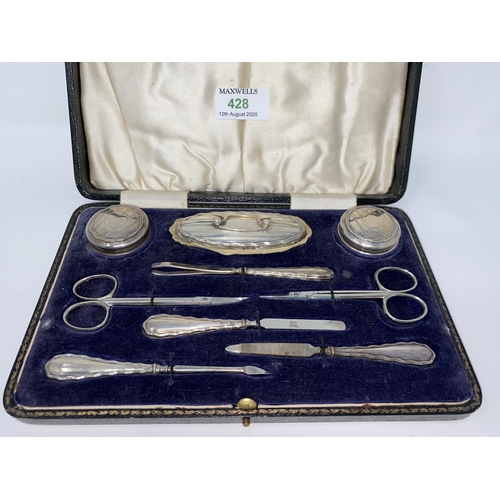 428 - A cased hall marked silver 9 piece engine turned manicure set Birmingham 1925