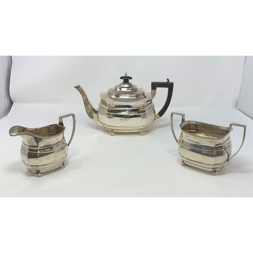 436 - A Georgian style rounded rectangular three piece hall marked silver tea set with ribbed body and bun... 