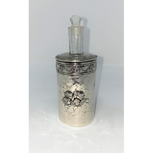 442 - An Edwardian hall marked silver cylindrical scent bottle enbosed with cherubs with glass liner and s... 