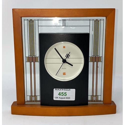 455 - A modern mantel clock by Bulova in wood and glass frame