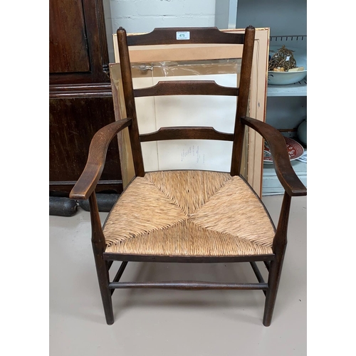 475 - An oak framed rush seat armchair
