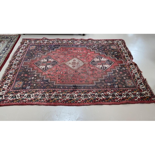 501 - A Persian hand knotted rug with red ground