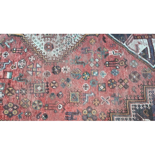 501 - A Persian hand knotted rug with red ground