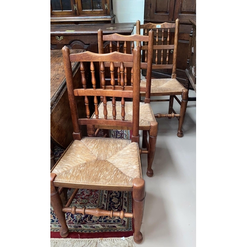 508 - A 19th century set of 7 Lancashire dining chairs in oak and elm with spindle backs and rush seats