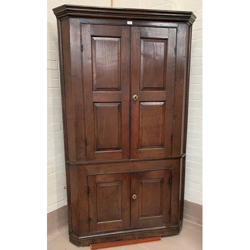 514 - A Georgian country made corner cabinet, full height and straight fronted, with twin fielded panel up... 