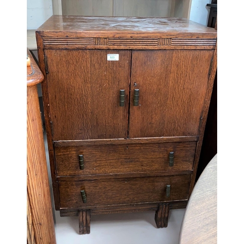 523 - A 1930's oak tallboy with double cupboard and 2 drawers