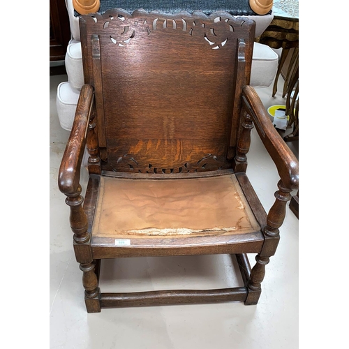 529 - A monks chair in carved oak with hinged top and pierced back, on turned supports (requires reupholst... 