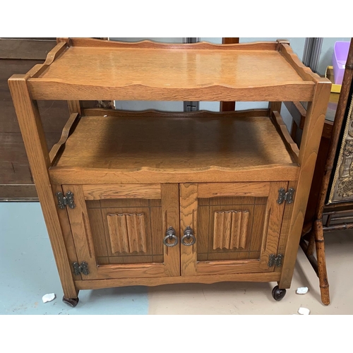 532 - A light oak 'Agincourt' tea trolley with double shelves over double linenfold panel doors