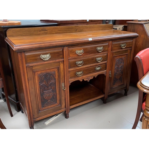 590 - An Edwardian carved mahogany sideboard of 2 cupboards and 5 drawers