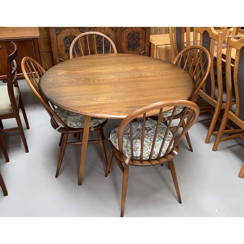 617 - An Ercol drop leaf dining table and 4 hoop back chairs