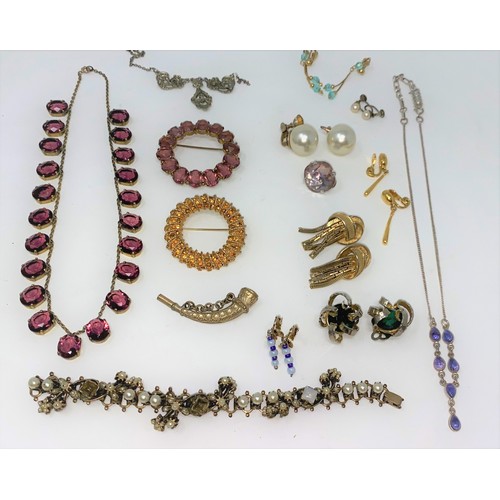 403 - An amethyst colour necklace, brooches, earrings etc