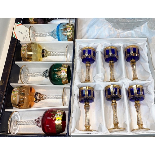 269 - A European set of small wine glasses in blue and gilt; a similar set of Alfa & Omega Italian coloure... 