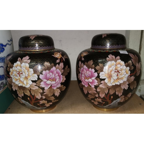 103 - A pair of Chinese cloisonne lidded ginger jars black ground decorated with flowers