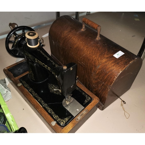 61 - A Singer hand operated sewing machine in oak case
