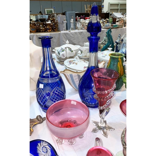 287 - 2 blue overlaid glass decanters; 4 pieces of cranberry glass; an iridescent glass vase on silver pla... 