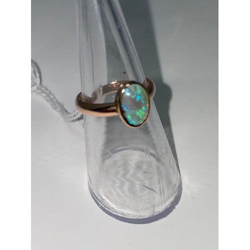 384 - A 9 carat hallmarked rose gold ring, set oval opal