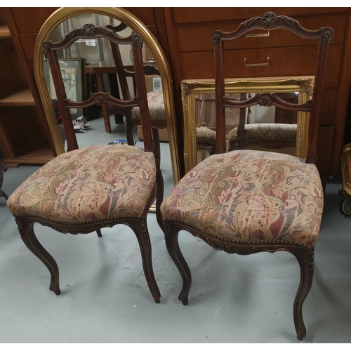 495 - A set of 4 French Provincial salon chairs with carved decoration and cabriole legs upholstered in ta... 
