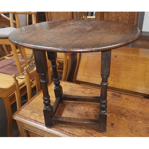 511 - A reproduction oak occasional table with oval drop leaf top; an armchair with rush seat and ladder b... 