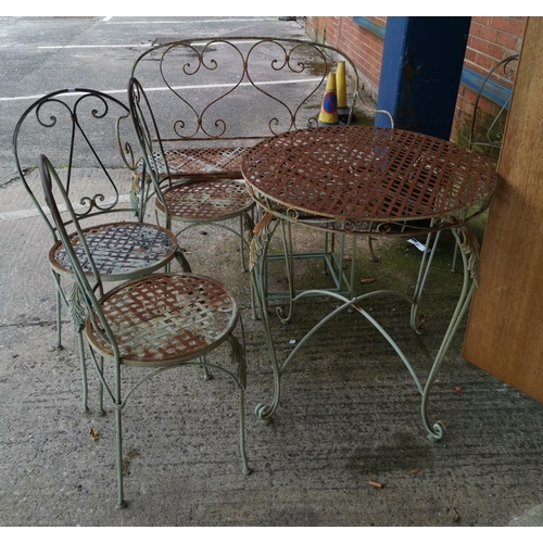 527 - A wrought metal patio set comprising table, chairs and settee