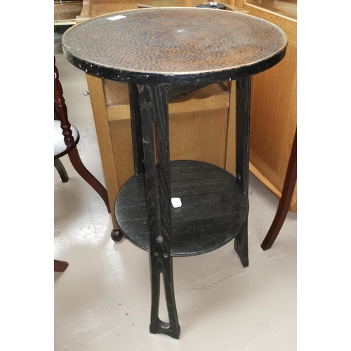 530 - A German Arts & Crafts ebonised table with copper circular top, undershelf height 73 cm