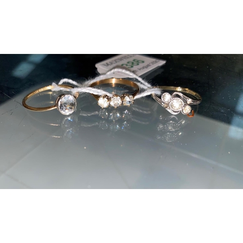 386 - Three gem set dress rings, 3.4 gm; a pearl effect stick pin, boxed