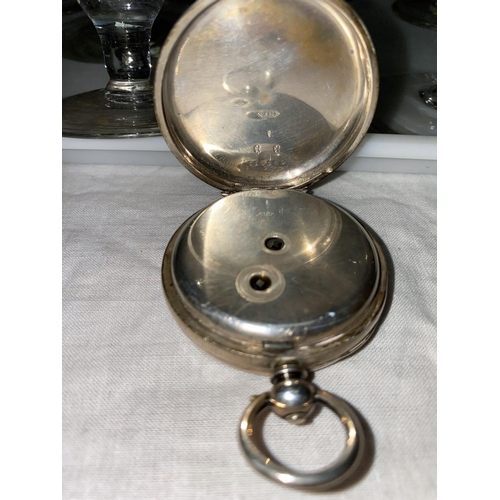 373 - An oval faced key wound gent's pocket watch in engine turned silver case