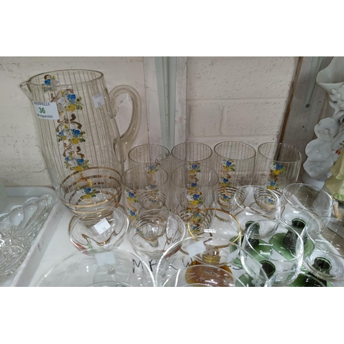 36 - A 1950's squash set with painted gilt and floral decoration; a selection of drinking glasses
