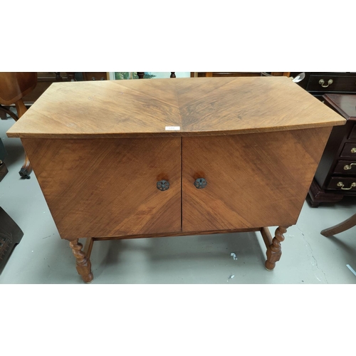 594 - A walnut side cabinet with 2 doors, on barley twist legs