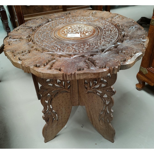 597 - A Far Eastern occasional table with circular carved inlaid top